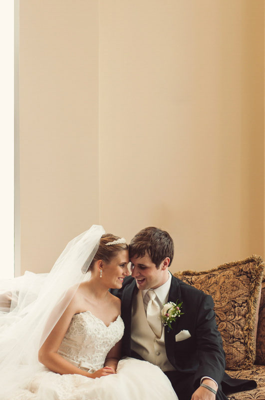snuggling bride and groom at blackshear baptist church