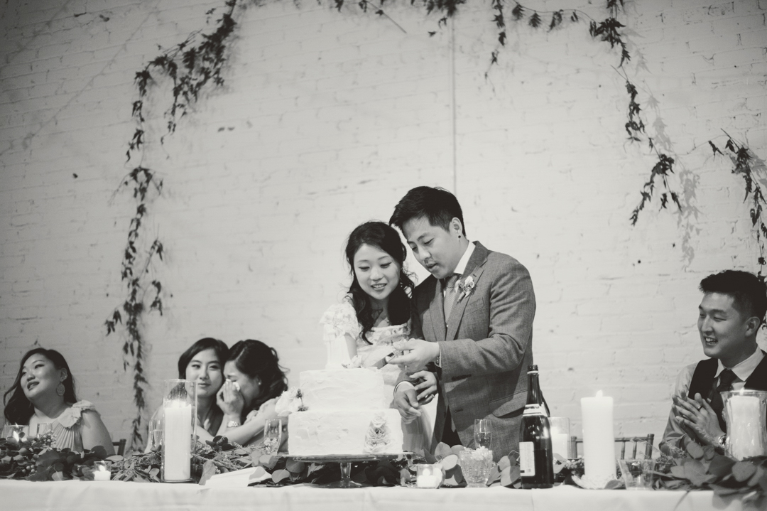 Atlanta Marietta Brickyard Wedding Photography with bride and groom cutting cake