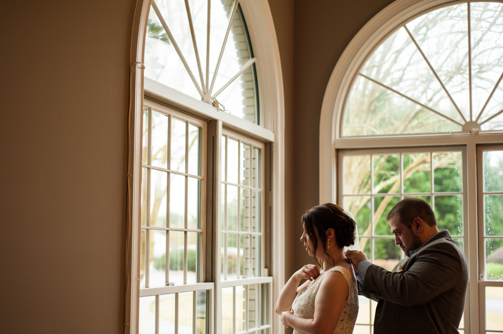 Bride and groom help each other get ready at their Atlanta area elopement. 
