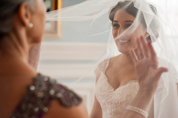 bride puts on veil photographed by GA wedding photographer YouAreRaven