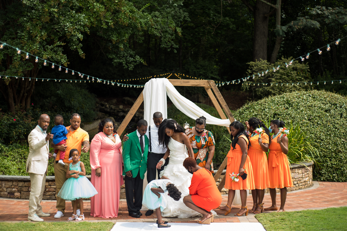 bride poses with family after wedding ceremony