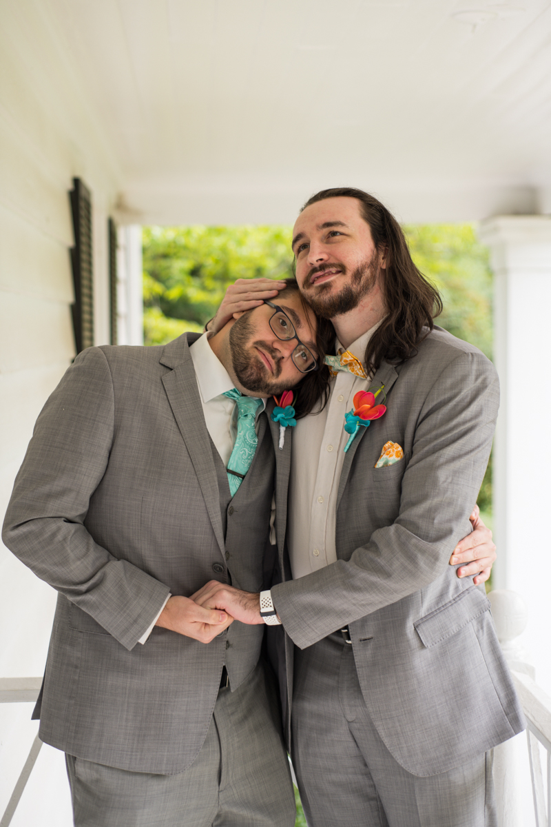 groom poses for funny photos with groomsman