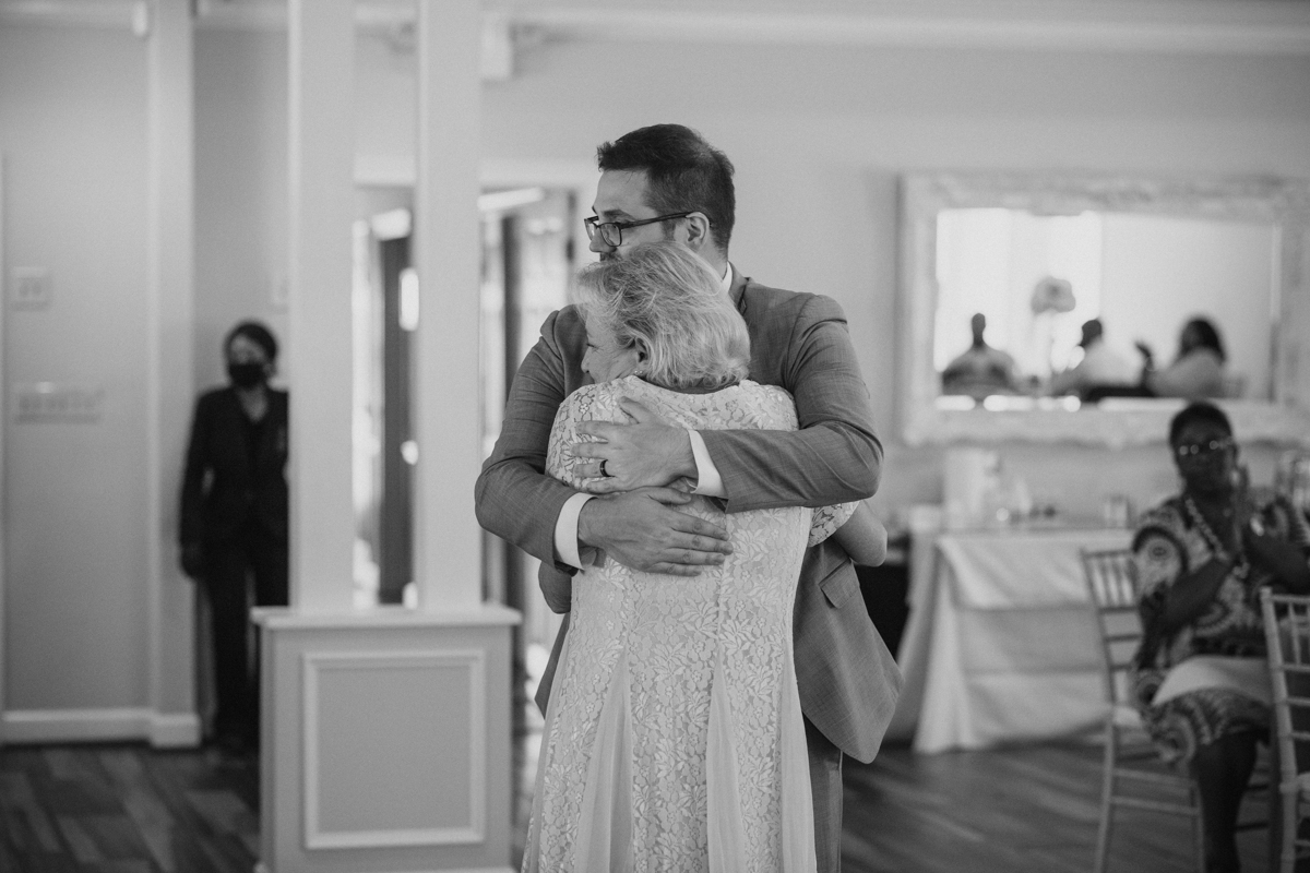groom dances with mom during wedding reception