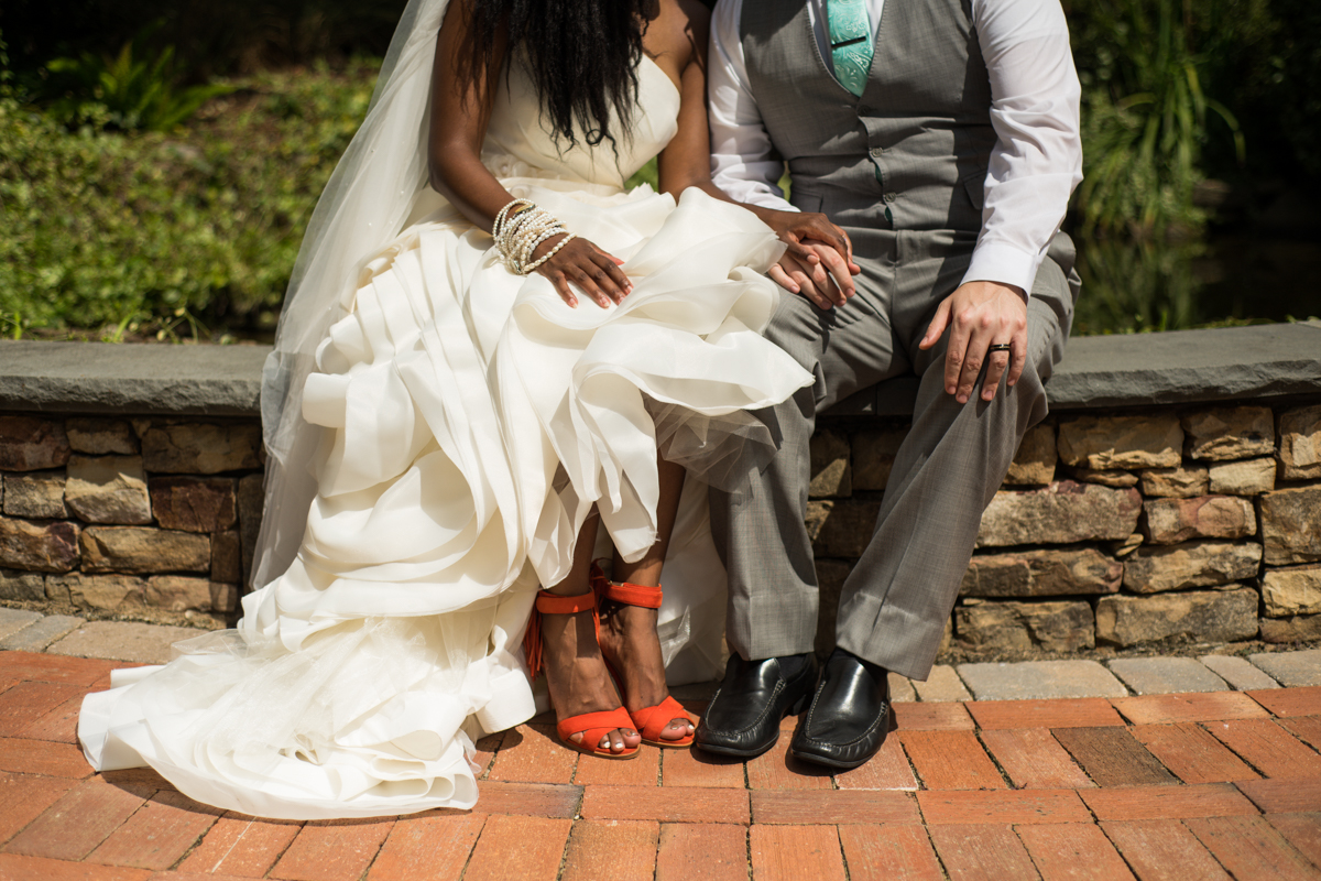 bride shows off orange heels
